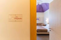 Łóżko lub łóżka w pokoju w obiekcie Le Magnolie Hotel