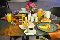 a table with breakfast foods and drinks on it at Wifala Harmony Hotel in Urubamba