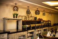 a restaurant with a counter with pots and pans at Central Hotel Ridge in Accra