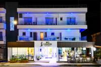 a white building with a restaurant in front of it at Mikes Kanarium City Hotel in Larnaka