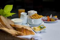 a table with a plate of food with bread and butter at Solitaire Damnak Villa Hotel in Siem Reap