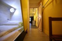 a small room with a bed and a hallway at Hive Bed and Backpacker蜂巢膠囊旅店 in Hualien City