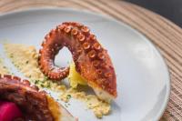a plate of food with a pretzel and other foods at Boutique Hotel Planlim in Ortisei