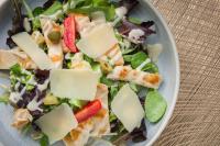 a salad with cheese and vegetables on a plate at Boutique Hotel Planlim in Ortisei