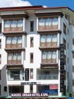 a white building with a sign in front of it at Naksel Urban Hotel &amp; Spa in Thimphu