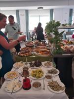 a buffet of food on a long table with people at Mediterranean Beach Resort in Laganas