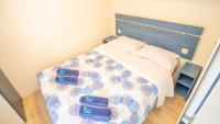 A bed or beds in a room at Happy Camp Mobile Homes in Camping Cisano San Vito