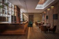 a restaurant with a bar with chairs and tables at Stylish 2BR at Paramount Hotel Midtown in Dubai