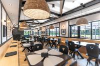 a dining room with tables and chairs and windows at Casa Roben in Rîu de Mori