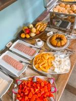 a table topped with lots of different types of food at Pousada Vila Tamarindo Eco Lodge in Florianópolis