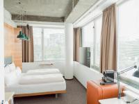 A bed or beds in a room at Hotel Daniel Vienna - Smart Lifestyle Near City Centre