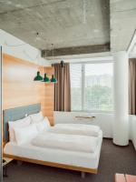 A bed or beds in a room at Hotel Daniel Vienna - Smart Lifestyle Near City Centre