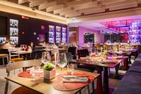 Un restaurante con mesas y sillas con copas de vino. en Adesso Hotel, en Roma