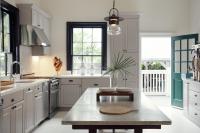 a kitchen with white cabinets and a table at Ridley House - Key West Historic Inns in Key West