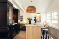 a kitchen with a bar with stools and a table at Ridley House - Key West Historic Inns in Key West