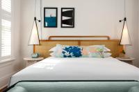 a bedroom with a large white bed with two lamps at Ridley House - Key West Historic Inns in Key West