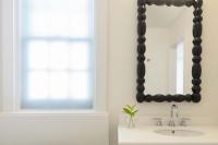 a bathroom with a black mirror and a sink at Ridley House - Key West Historic Inns in Key West