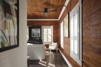 a living room with wood paneling and a ceiling at Ridley House - Key West Historic Inns in Key West