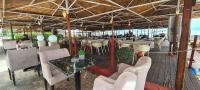 a restaurant with a table and chairs on the beach at Veranda Rooms to Let in Neoi Epivates
