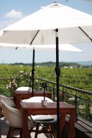 a wooden table with a white umbrella on a balcony at Weingut Magdalenenhof in Rüdesheim am Rhein