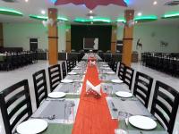 a long table in a banquet hall with a red table cloth at Rubystone Shiv Vilas Palace in Bharatpur