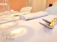 a table with a white table cloth with a fork and a napkin at Hotel Palazzo Papaleo in Otranto