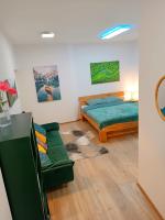 a bedroom with a bed and a couch at Apartments Romantic and Family Room Zemlinski in Payerbach