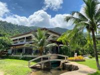 a bridge in front of a building with palm trees at Koh Chang Bailan Beach Resort in Ko Chang