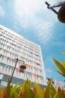 a white building with a lot of windows at HARRIS Hotel Batam Center in Batam Center