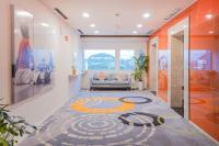 a living room with a couch and a carpet at HARRIS Hotel Batam Center in Batam Center