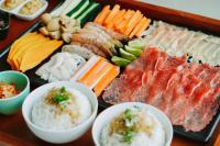 a tray of different types of food on a table at HARRIS Hotel Batam Center in Batam Center