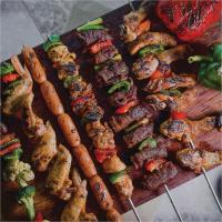 a tray of food with meat and vegetables on it at HARRIS Hotel Batam Center in Batam Center