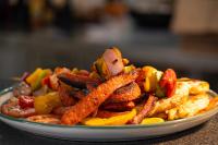 een bord friet en ander eten op een tafel bij La Dulce Vista Hotel & Villas - Sierra Madre Puerto Vallarta in Puerto Vallarta