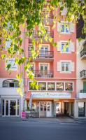 a pink building with a north entrance on a street at Hôtel Mont-Brison in Briançon