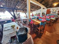 een restaurant met tafels en stoelen en mensen erin bij Evangeline Resort in Pagudpud