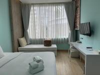 a hotel room with a bed and a desk at Beat Hotel Bangkok in Bangkok