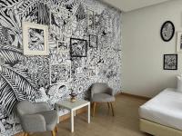 a living room with a black and white wallpaper at Beat Hotel Bangkok in Bangkok
