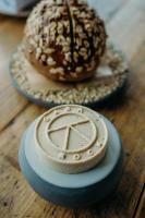 a doughnut sitting on a table next to a plate at Gara Rock in Salcombe