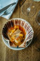 a bowl of food on a plate on a table at Gara Rock in Salcombe