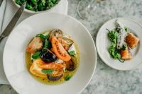 a plate of food with shrimp and vegetables on a table at Gara Rock in Salcombe