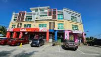 a building with cars parked in a parking lot at Hotel SN Legacy in Kuala Terengganu