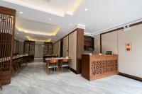 a restaurant with tables and chairs in a room at Hanoi International Hotel in Hanoi