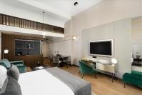 a hotel room with a bed and a flat screen tv at Emerald Downtown Luxury Suites by Continental Group in Budapest