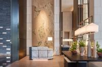 a lobby of a hotel with a reception desk at Luoyang Marriott Hotel in Luoyang