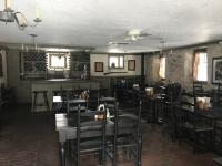 a restaurant with tables and chairs in a room at The Inn on the Olde Homestead in Waukesha