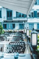 a row of tables and chairs on a balcony at Storchen Zürich - Lifestyle Boutique Hotel in Zürich