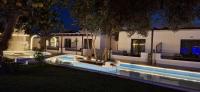 a house with a swimming pool at night at Skiathos Holiday Resort in Skiathos