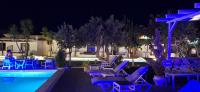 a swimming pool with blue chairs next to a resort at Skiathos Holiday Resort in Skiathos