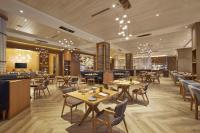 a restaurant with tables and chairs and a bar at Hilton Manila Newport World Resorts in Manila
