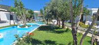 a view of the pool at a resort with palm trees at Skiathos Holiday Resort in Skiathos